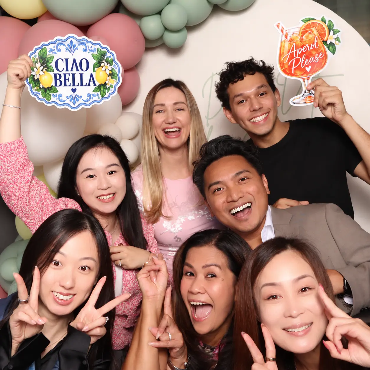 A group of guests gathering together in the photo booth frame
