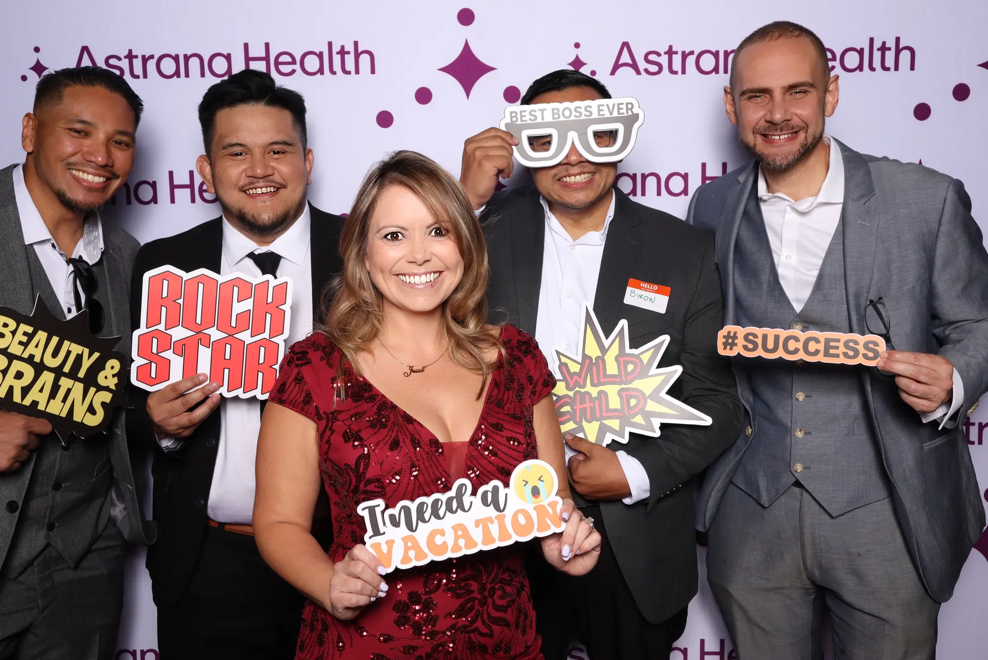Guests celebrating with playful photo booth props at a branded event